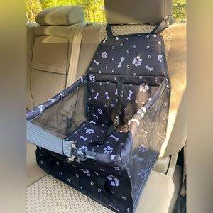 A black booster car seat for you 15 and under pound furry friend.